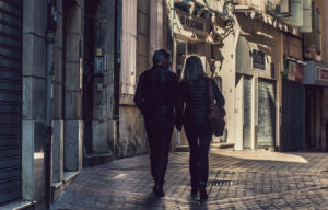 Couple walking in European street.